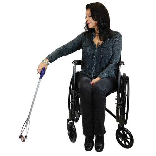 Woman in a wheelchair holding a white cane on a white background