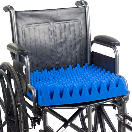 Wheelchair with a blue textured cushion on a white background