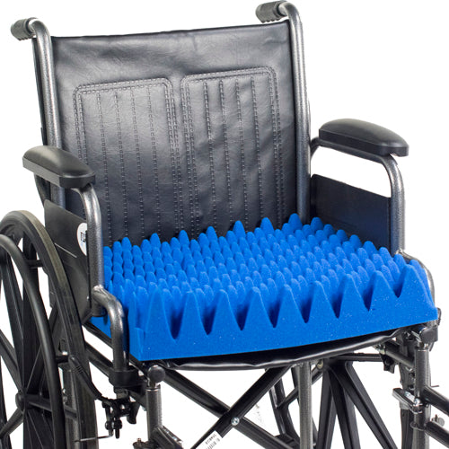 Wheelchair with a blue textured cushion on a white background