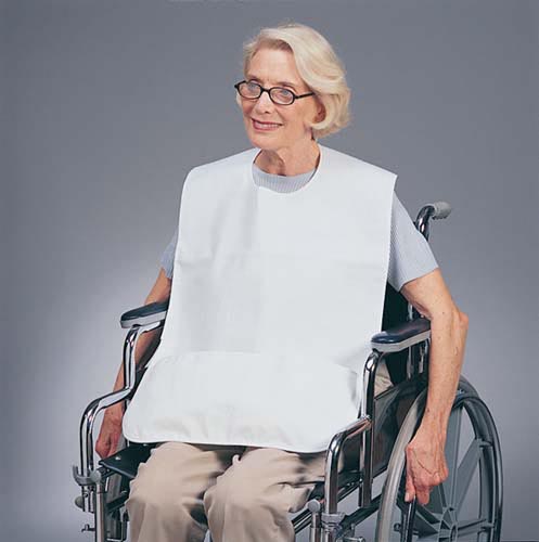 Woman in a wheelchair wearing a white bib against a gray background