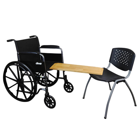 Black wheelchair with a wooden table and black chair on a white background
