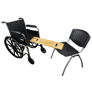 Wheelchair with attached wooden table and black chair on a white background
